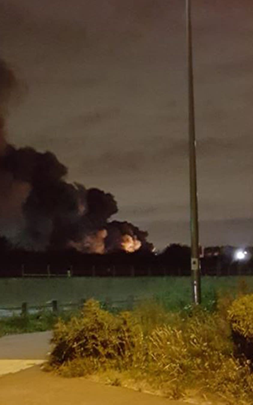 Smoke billowing into the air as five fuel tankers are on fire in a "major incident" on an industrial estate in Purfleet, Essex - Credit: @deanthurrockrfc/Twitter