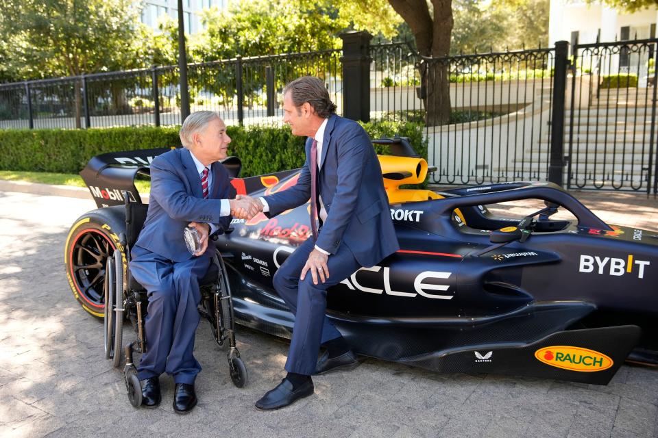 Gov. Greg Abbott, left, and Circuit of the Americas chairman Bobby Epstein get a close-up look at a Formula One car at the Governor's Mansion on Monday. This year's F1 race in Austin is on Sunday.