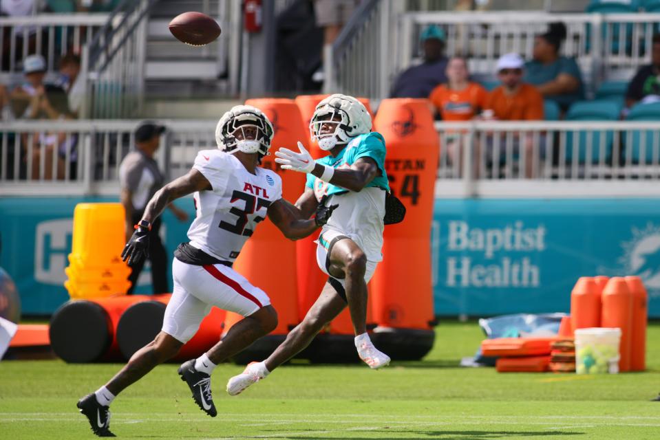 Aug 6, 2024; Miami Gardens, FL, USA; Miami Dolphins wide receiver Malik Washington (83) catches the football against Atlanta Falcons cornerback Antonio Hamilton Sr. (33) during a joint practice at Baptist Health Training Complex. Mandatory Credit: Sam Navarro-USA TODAY Sports