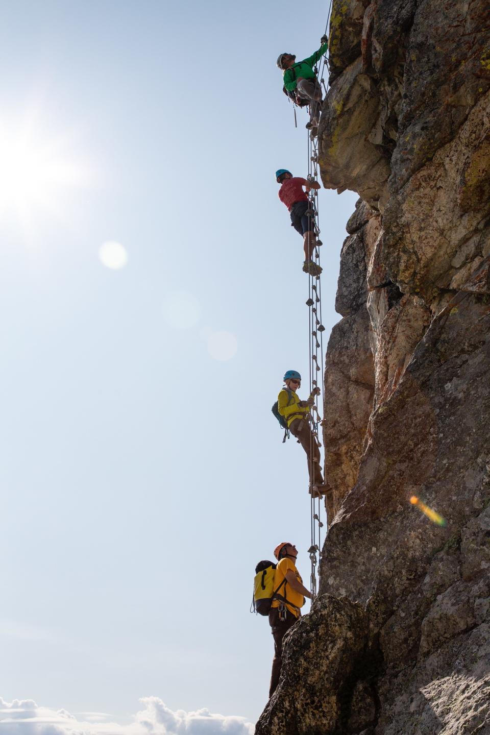 Climbers ascend a vertical via ferrata at Jackson Hole Mountain Resort in Jackson Hole, Wyo.