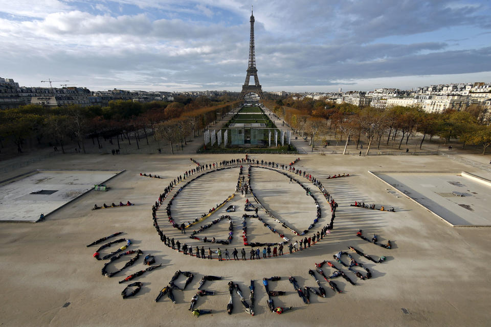 <p>Hundreds of environmentalists arrange their bodies to form a message of hope and peace in front of the Eiffel Tower in Paris, France, Dec. 6, 2015, as the World Climate Change Conference 2015 (COP21) continues at Le Bourget near the French capital. (Benoit Tessier/Reuters) </p>