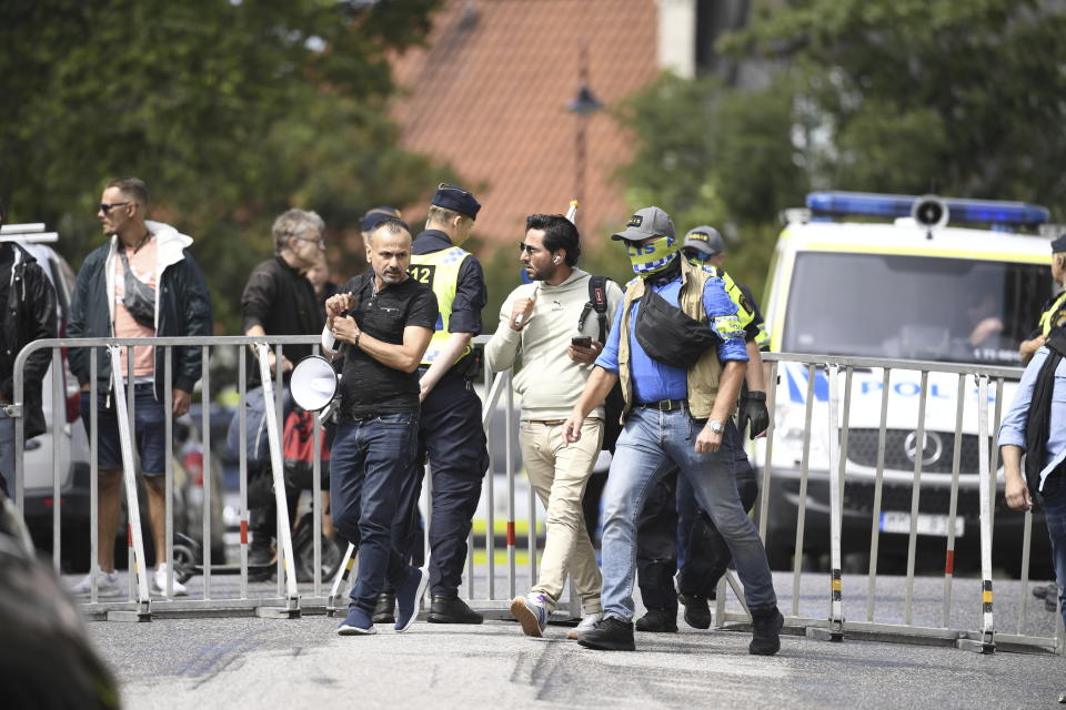 Protestor Salwan Momika is escorted by police to a location outside the Iraqi embassy in Stockholm, Thursday, July 20, 2023, where he is going to burn a copy of the Quran and the Iraqi flag. (Caisa Rasmussen/TT via AP)