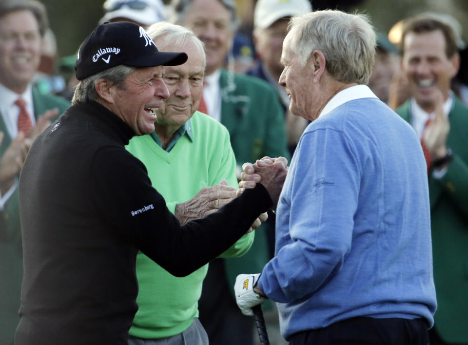 From left, Gary Player, Arnold Palmer and Jack Nicklaus shake hands after hitting ceremonial drives on the first tee during the first round of the Masters golf tournament Thursday, April 10, 2014, in Augusta, Ga. (AP Photo/Charlie Riedel)