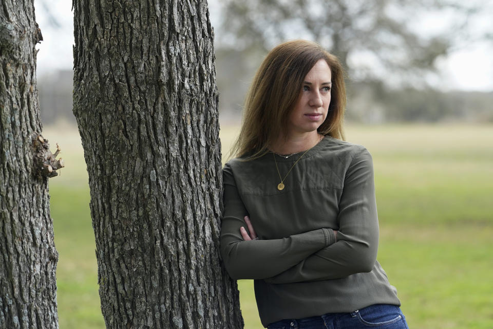 Rachel Van Lear poses for a portrait at her home in Buda, Texas, Tuesday, March 9, 2021. Van Lear says she was in great shape when she got sick. At 35, she had no underlying illnesses and was a busy mother of three who often worked out. First came a chest cold, then a high fever. A flu test came back negative, so her doctor tested for COVID-19. Results were positive. Soon after she developed blinding headaches, debilitating fatigue and nausea so severe that she needed ER treatment to replace fluid. (AP Photo/Eric Gay)