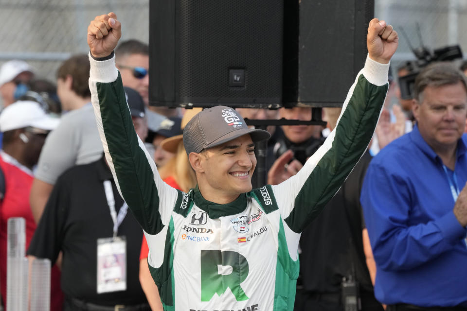 Alex Palou acknowledges fans after winning the IndyCar Detroit Grand Prix auto race, Sunday, June 4, 2023, in Detroit. (AP Photo/Carlos Osorio)