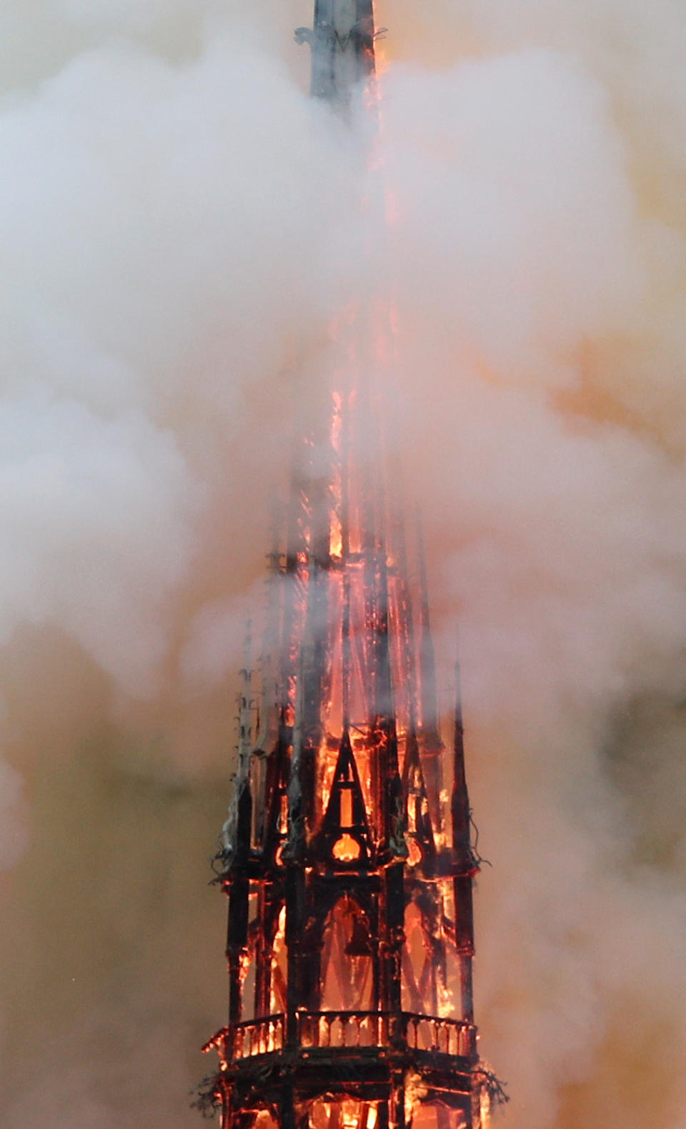 Smoke billows as fire engulfs the spire of Notre Dame Cathedral. Source: Reuters