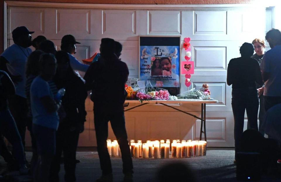 About 100 people gathered for a vigil held on the driveway outside the home where Yanelly Solorio Rivera, 18, and her 3-week-old girl, Celine Solorio Rivera lived, on Tuesday evening, Sept. 27, 2022 south of Fresno. The two were found dead inside the home after being shot Saturday. Police are still searching for the killer.