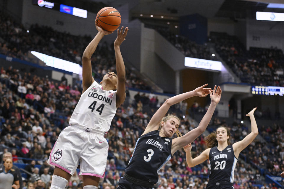 UConn's Aubrey Griffin (44) goes up for a basket while fouled by Villanova's Lucy Olsen (3) in the second half of an NCAA college basketball game, Sunday, Jan. 29, 2023, in Hartford, Conn. (AP Photo/Jessica Hill)