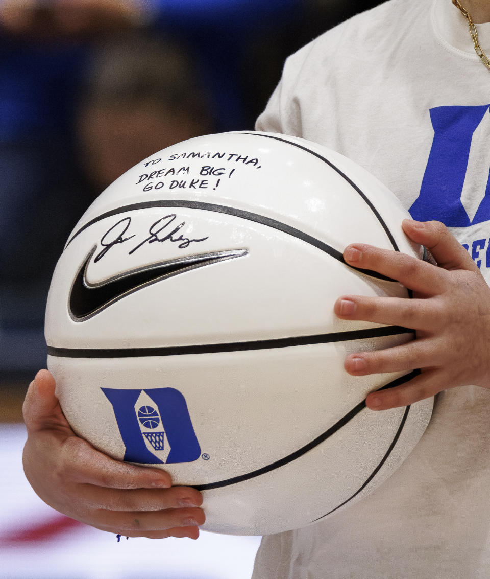 Samantha DiMartino holds a basketball signed by Duke coach Jon Scheyer, given as a part of the Scheyer Family Kid Captains Program, which recognizes patients and families of Duke Children's hospital, in Durham, N.C., Wednesday, Feb. 28, 2024. (AP Photo/Ben McKeown)