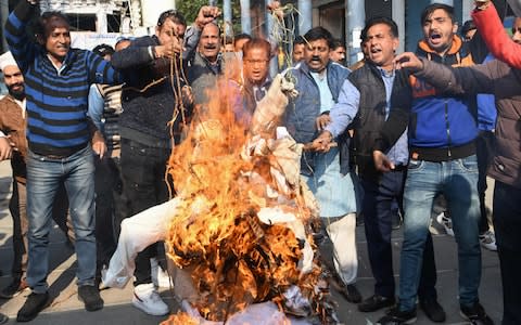 Protesters burned effigies of "rapists" in Shiv Sena on Thursday - Credit: NARINDER NANU/AFP/GETTY IMAGES