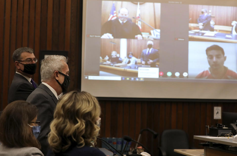 Santa Cruz County District Attorney Jeff Rosell speaks as proceedings get under way on Friday, June 12, 2020 during the arraignment of Steven Carrillo, seen in a video link at far right, for the killing of Santa Cruz Sheriff's Deputy Damon Gutzwiller in Santa Cruz, Calif. (Shmuel Thaler/Santa Cruz Sentinel via AP)