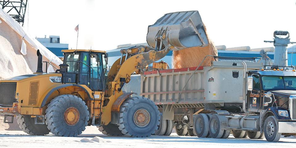 The salt yard at the Quincy Shipyard is busy on Wednesday, Jan. 26, 2022 as trucks line up to haul road salt to towns in preparation for a snow storm this weekend.