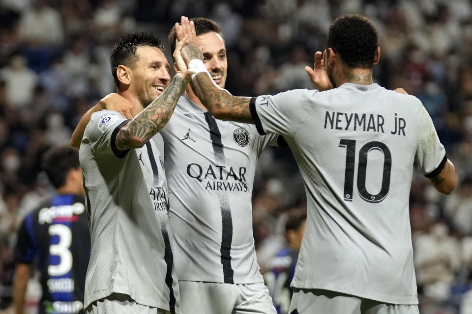 Paris Saint-Germain's Lionel Messi celebrates his goal with his teammates Pablo Sarabia and Neymar during a friendly soccer match between Paris Saint-Germain and Gamba Osaka in Suita, western Japan, Monday, July 25, 2022. (AP Photo/Hiro Komae)