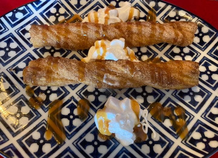 The churros at Victoria's Steakhouse and Mexican Grill on the East Side are made in house and are delicious.