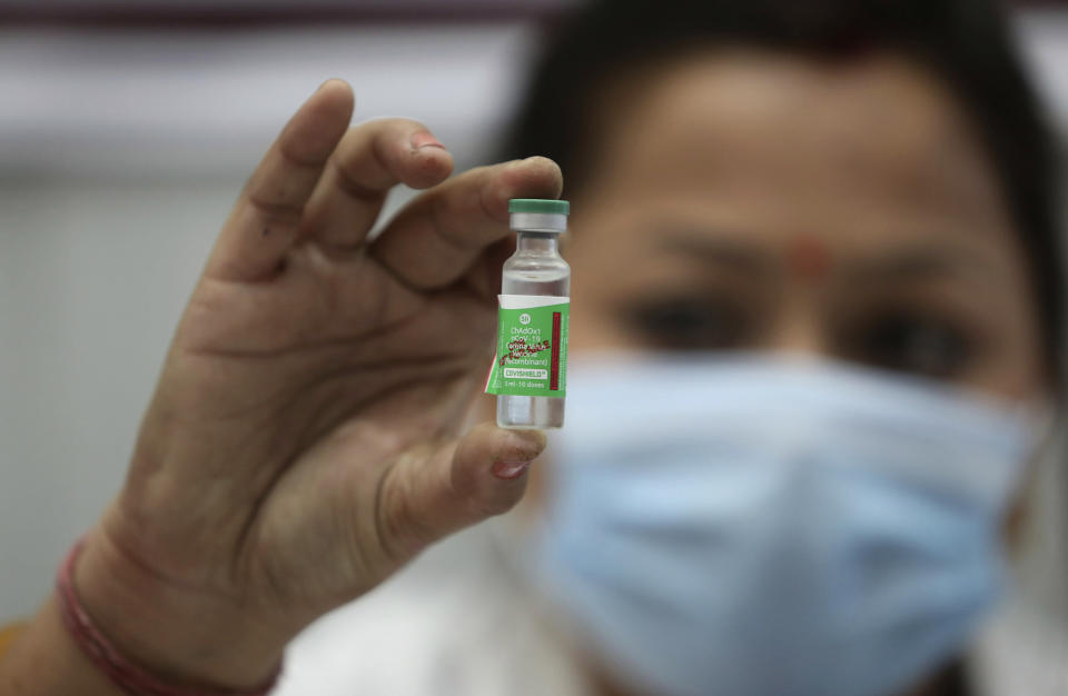 FILE - In this Saturday, Jan. 16, 2021, file photo, an Indian doctor shows a COVID-19 vaccine at a government Hospital in Jammu, India. India started exporting COVID-19 vaccines to its neighboring countries on Wednesday, Jan. 20. To start with, India will send 150,000 shots of the AstraZeneca vaccine to Bhutan and 100,000 shots to Maldives. Afterwards, vaccines will be sent Bangladesh, Nepal, India’s foreign ministry said. (AP Photo/Channi Anand, File)