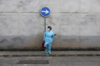 Nurse Pilar Rodríguez arrives to start visiting her patients in the town of Sa Pobla on the Spanish Balearic Island of Mallorca, Spain, Friday, April 30, 2021. Rodríguez and her co-workers carry the vaccines in hand-held coolers to the first home on their day's circuit, where they prepare the shots. From that first stop, they walk to the other homes to make sure they avoid any jolts a car could deal the shots. (AP Photo/Francisco Ubilla)