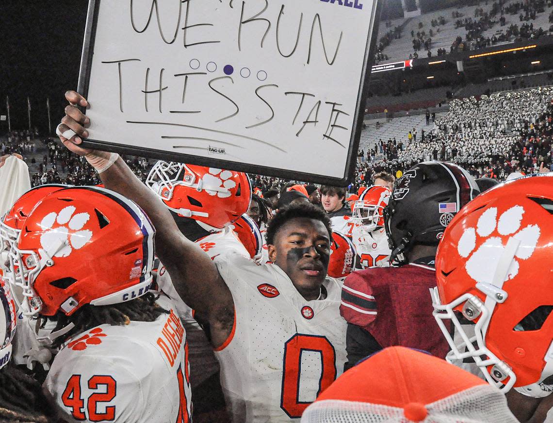 Nov 25, 2023; Columbia, South Carolina, USA; Clemson Tigers linebacker Barrett Carter (0) holds a sign “We Run This State” near South Carolina Gamecocks linebacker Grayson Howard (5) after defeating South Carolina at Williams-Brice Stadium. Clemson won 16-7. Mandatory Credit: Ken Ruinard-USA TODAY Sports Ken Ruinard/Ken Ruinard-USA TODAY Sports