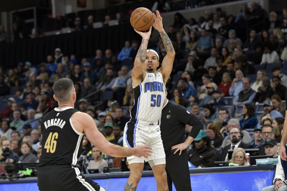 Orlando Magic guard Cole Anthony (50) looks to shoot against Memphis Grizzlies guard John Konchar (46) in the second half of an NBA basketball game Friday, Jan. 26, 2024, in Memphis, Tenn. (AP Photo/Brandon Dill)