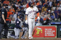 Houston Astros' Jon Singleton, right, drops his bat as he watches his three run home run in front of Cleveland Guardians catcher Bo Naylor, centerm and umpire Stu Scheurwater, left, during the fourth inning of a baseball game Tuesday, April 30, 2024, in Houston. (AP Photo/Michael Wyke)