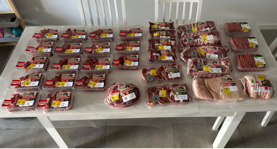Woolworths meat haul on table.
