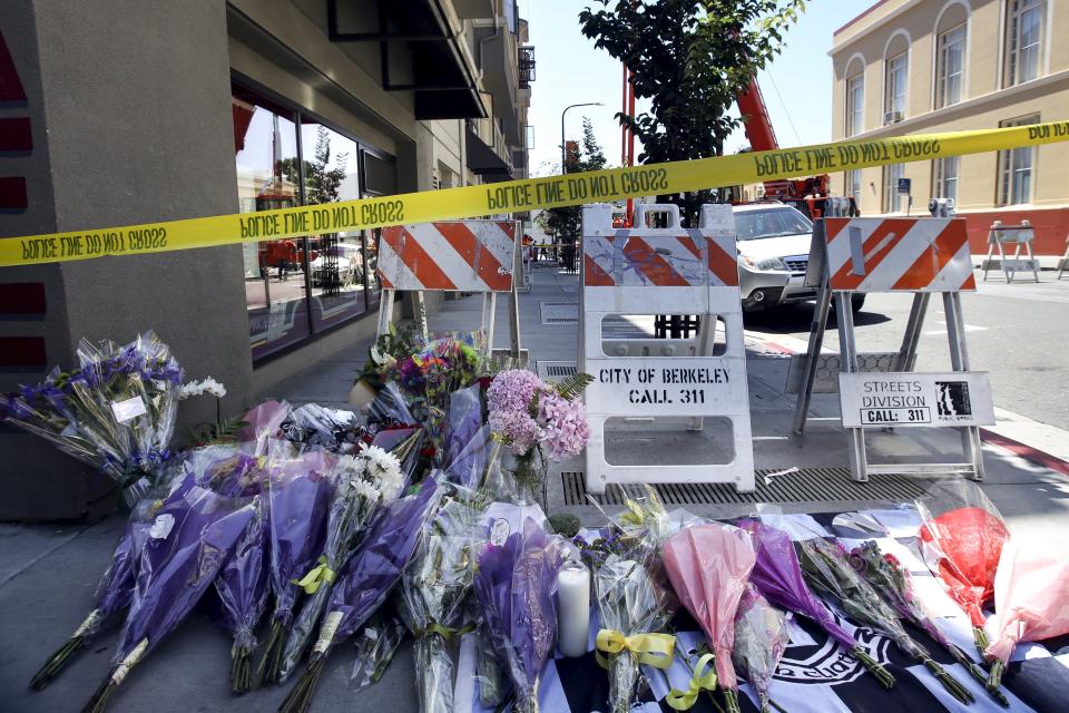 Flowers are laid at a memorial near the scene of a 4th-story apartment building balcony collapse in Berkeley
