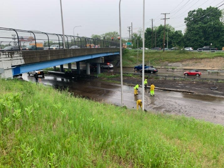 Workers clear flooding from Route 10 South in Providence.