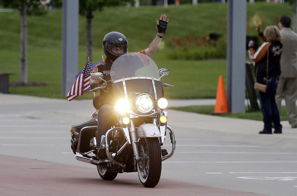 FILE – In this Aug. 2, 2013 file photo, Wisconsin Governor Scott Walker rides a Harley Davidson motorcycle to the motorcycle museum in Milwaukee. (AP Photo/Jeffrey Phelps, File)