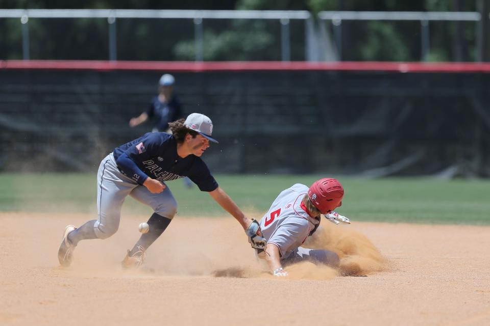 Savannah Christian's Josh Gates slides safely into second as Fellowship Christian's Jack Rickheim loses the ball during Wednesday's state playoff game at Savannah Christian.