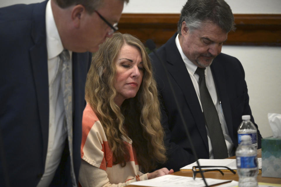 Lori Vallow Daybell sits between her attorneys and looks at notes during her sentencing hearing at the Fremont County Courthouse in St. Anthony, Idaho, Monday, July 31, 2023. Idaho mother Vallow Daybell has been sentenced to life in prison without parole Monday in the murders of her two youngest children and a romantic rival in a case that included bizarre claims that her son and daughter were zombies and that she was a goddess sent to usher in the Biblical apocalypse. (Tony Blakeslee/EastIdahoNews.com via AP, Pool)