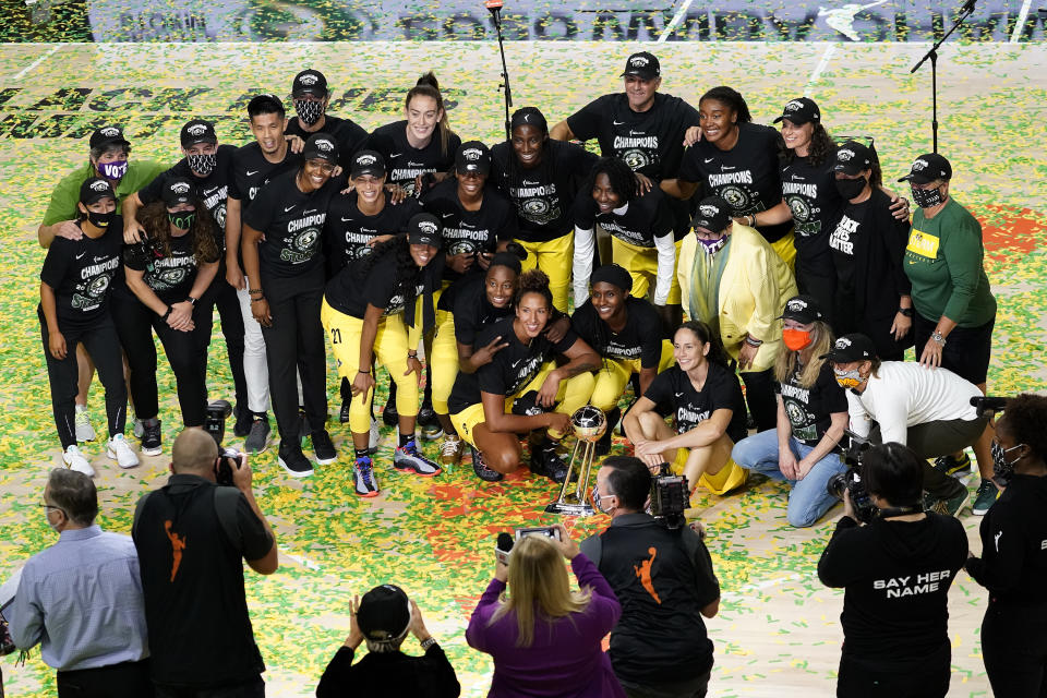 Members of the Seattle Storm organization celebrate after the team won basketball's WNBA Championship Tuesday, Oct. 6, 2020, in Bradenton, Fla. (AP Photo/Chris O'Meara)