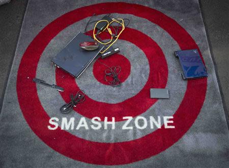 Computers and outdated electronic gadgets that have been smashed sit on a carpet during "Good Riddance Day" in Times Square in New York, December 28, 2013. REUTERS/Carlo Allegri