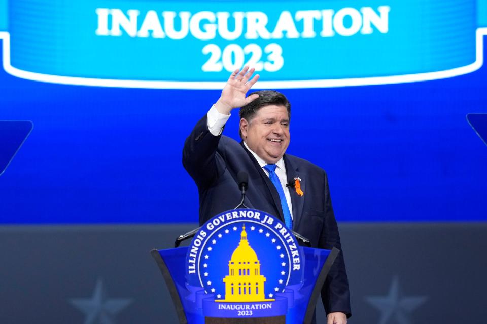 Gov. JB Pritzker waves to the crowd after delivering his inaugural address during ceremonies Monday in Springfield.