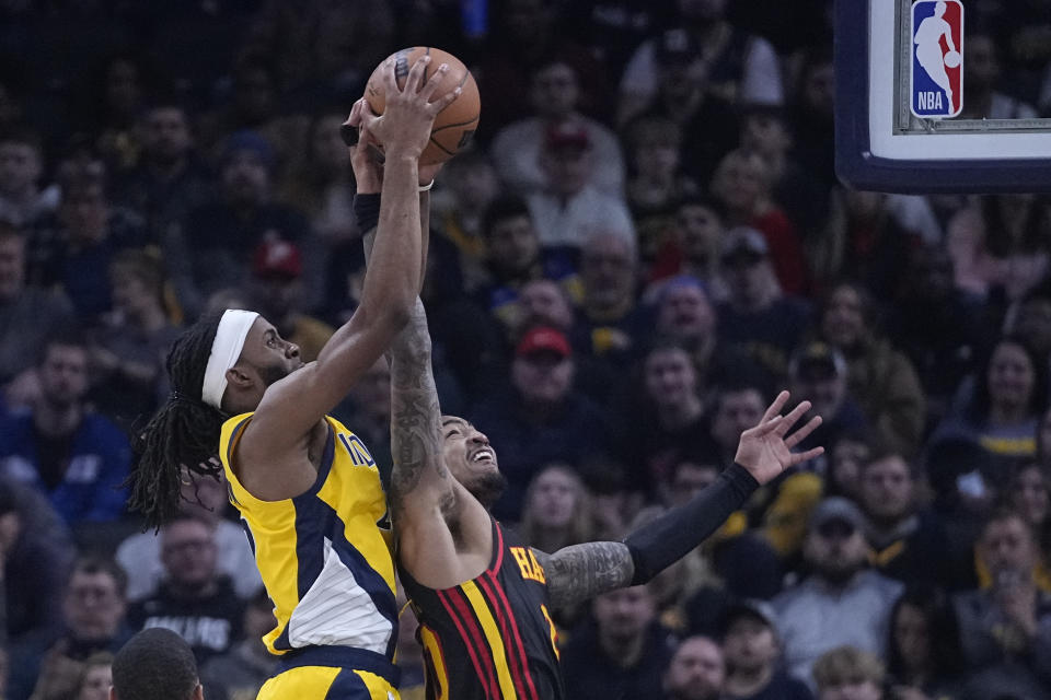 Indiana Pacers' Isaiah Jackson (22) and Atlanta Hawks' John Collins (20) vie for a rebound during the first half of an NBA basketball game Friday, Jan. 13, 2023, in Indianapolis. (AP Photo/Darron Cummings)