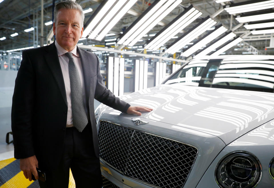 Adrian Hallmark, CEO of Bentley Motors, poses for a photograph next to one of his company&#39;s cars on the production line of their factory in Crewe, Britain January 22, 2019. REUTERS/Phil Noble