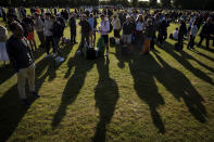 People queue to enter the ground before the start of day one of the Wimbledon tennis championships in London, Monday, June 27, 2022. (Aaron Chown/PA via AP)