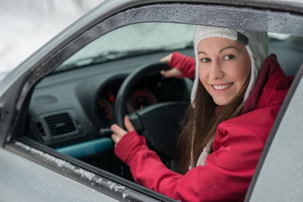 woman driving in winter on snow ...