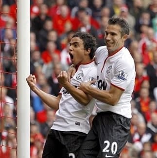 Manchester United's Rafael Da Silva, left, celebrates scoring against Liverpool with teammate Robin van Persie during the English Premier League soccer match at Anfield, Liverpool, England,Sunday Sept. 23, 2012. Manchester United won the match 1-2. (AP Photo/PA, Peter Byrne) UNITED KINGDOM OUT NO SALES NO ARCHIVE