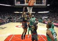 Nov 18, 2017; Atlanta, GA, USA; Atlanta Hawks forward John Collins (20) dunks against Boston Celtics guard Kyrie Irving (11) in the third quarter at Philips Arena. Also shown on the play is Atlanta Hawks guard Dennis Schroder (17). Mandatory Credit: Jason Getz-USA TODAY Sports