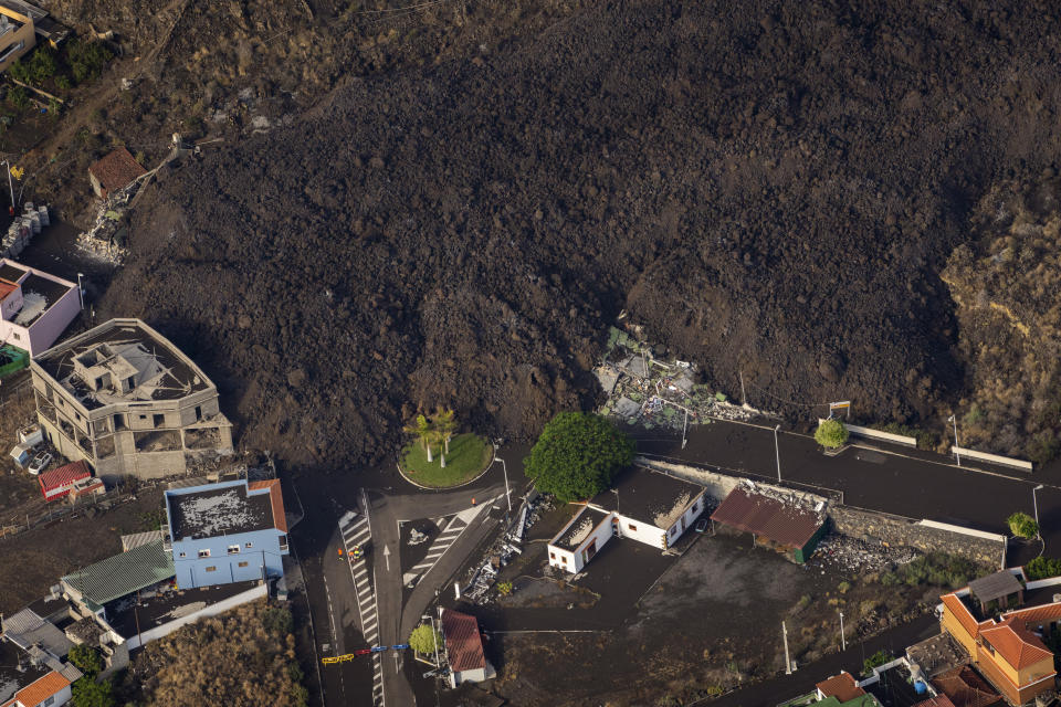 Lava from a volcano eruption flows on the island of La Palma in the Canaries, Spain, Thursday, Sept. 23, 2021. A volcano on a small Spanish island in the Atlantic Ocean erupted on Sunday, forcing the evacuation of thousands of people. Experts say the volcanic eruption and its aftermath on a Spanish island could last for up to 84 days. (AP Photo/Emilio Morenatti, Pool)