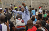 Former presidential candidate Moise Jean-Charles, center, chants anti-government slogans during a protest against Haitian Prime Minister Ariel Henry in Port-au-Prince, Haiti, Monday, Feb. 5, 2024. (AP Photo/Odelyn Joseph)