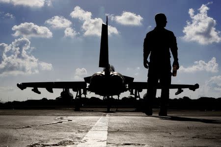 File photo - A British soldier walks by a Royal Air Force Typhoon aircraft before it takes off from RAF Akrotiri in Cyprus September 22, 2016, for a mission in Iraq. REUTERS/Petros Karadjias