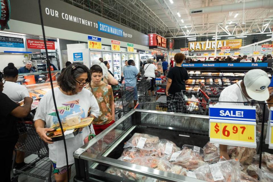 Shoppers brows the various food around the store during the grand opening of HEB on Wednesday, June 26 in Mansfield. HEB is a popular store among texans, known for their low prices as well as many food and appliance options.