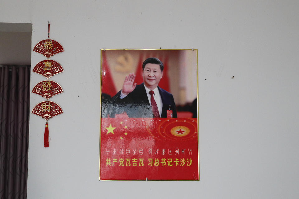 A poster showing an image of Chinese President Xi Jinping is displayed on a wall at a home of members of the Yi minority group in Xujiashan village in Ganluo County, southwest China's Sichuan province on Sept. 10, 2020. Communist Party Xi’s smiling visage looks down from the walls of virtually every home inhabited by members of the Yi minority group in a remote corner of China’s Sichuan province. Xi has replaced former leader Mao Zedong for pride of place in new brick and concrete homes built to replace crumbling traditional structures in Sichuan’s Liangshan Yi Autonomous Prefecture, which his home to about 2 million members of the group. (AP Photo/Andy Wong)