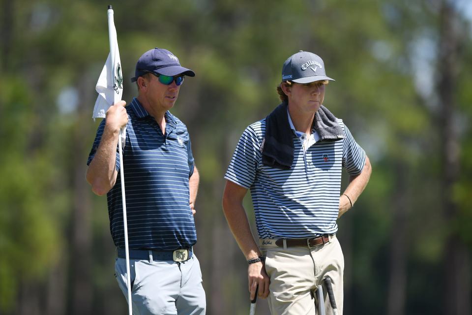 UNF golf coach Scott Schroeder talks with junior Andrew Riley during a practice round at the Timuquana Country Club on April 16.