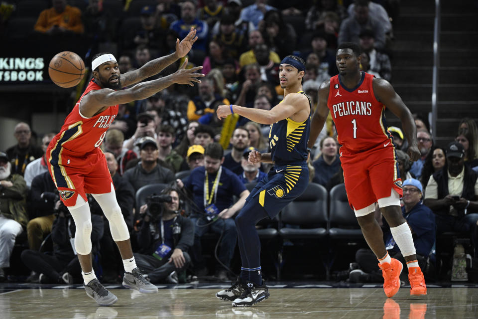 Indiana Pacers guard Andrew Nembhard (2) passes the ball past New Orleans Pelicans forward Naji Marshall (8) during the first quarter of an NBA Basketball game, Monday, Nov. 7, 2022, in Indianapolis, Ind. (AP Photo/Marc Lebryk)