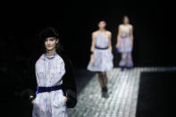 A model wears a creation as part of the Emporio Armani women's Fall-Winter 2024-25 collection presented in Milan, northern Italy, Thursday, Feb. 22, 2024. (AP Photo/Luca Bruno)