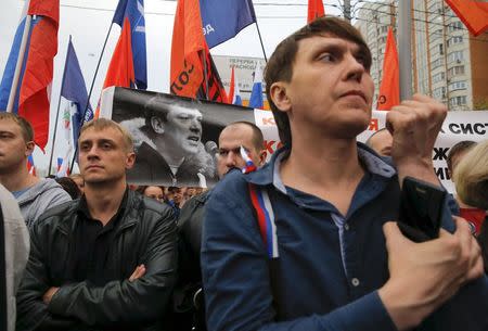 Opposition supporters holding a portrait of killed Kremlin critic Boris Nemtsov attend a rally in Moscow, Russia, September 20, 2015.