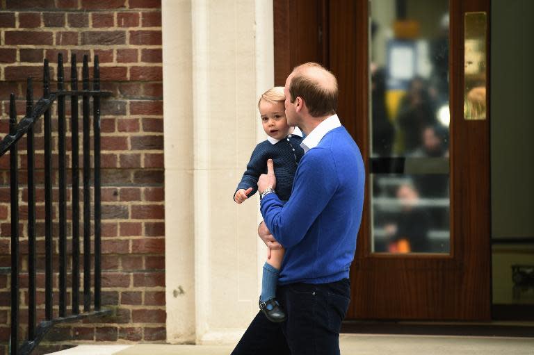 Britain's Prince William, Duke of Cambridge (R), kisses his son Prince George of Cambridge as they return to the Lindo Wing at St Mary's Hospital in central London, on May 2, 2015