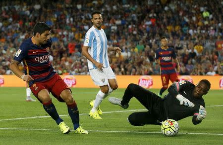 Barcelona's Luis Suarez (L) tries to score against Malaga's goalkeeper Carlos Kameni during their Spanish first division soccer match at Camp Nou stadium in Barcelona, Spain, August 29, 2015. REUTERS/Albert Gea