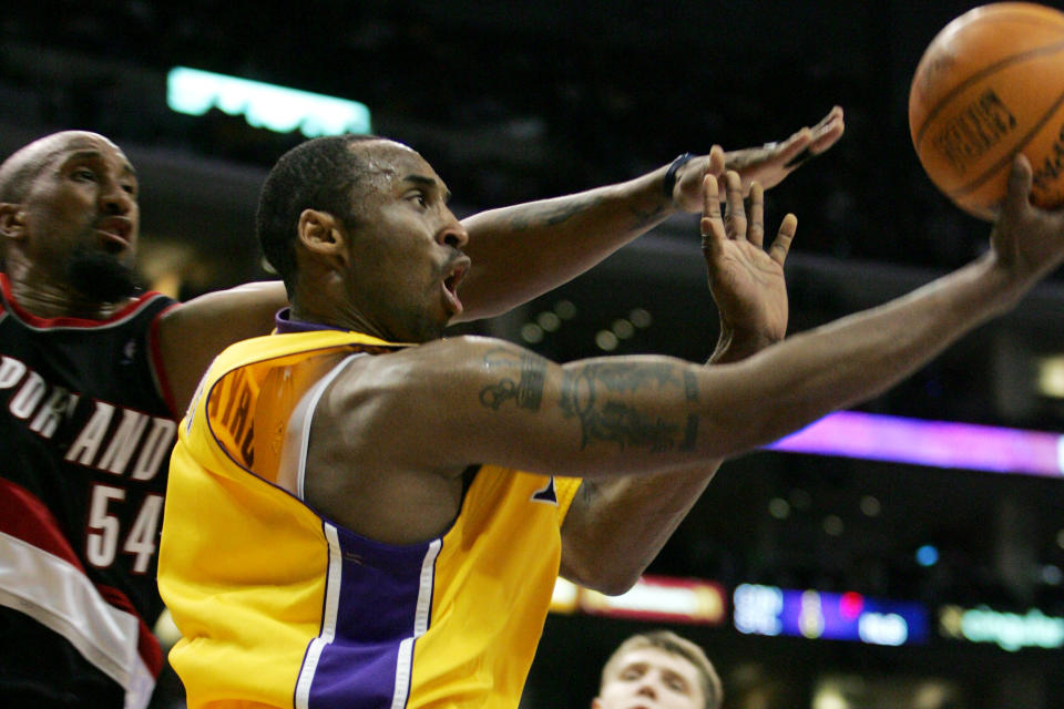 Los Angeles Lakers' Kobe Bryant goes up for a shot while being guarded by Portland Trail Blazers' Brian Skinner during the second half of an NBA basketball game Friday, April 14, 2006, in Los Angeles. (AP Photo/Jeff Lewis)